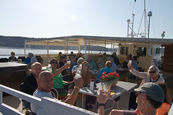 People outdoors raising glasses